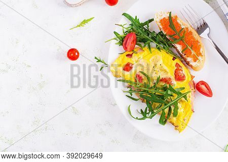 Omelette With Tomatoes, Cheese, Ham And Sandwich Wich Red Cavier On Plate.  Frittata - Italian Omele