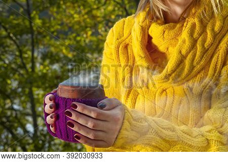 Close-up View Of Ceramic Cup Of Hot Coffee Ortea In Female Hand. Hot Beverege Drink In Autumn Park. 