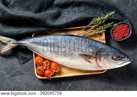Fresh Whole Japanese Amberjack. Raw Fish Yellowtail. Black Background. Top View
