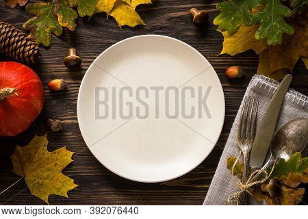 Autumn Table Setting With Craft Plate, Silverware And Fall Decorations. Dark Wooden Table, Toned Ima