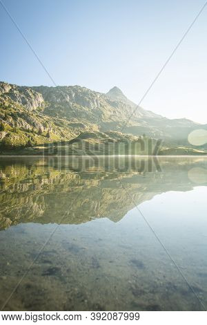 Scenic Bettmer Lake Near Fiesch In Wallis, Switzerland. Reflection On The Lake At Sunrise