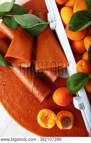 Apricot Pastille Is Rolled Into A Tube Or Cone. Apricots In A White Wooden Box. Natural And Dietary 