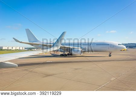 View From The Airplane Window Of The Wing And Another Large Airliner While Taxiing Before Take Off