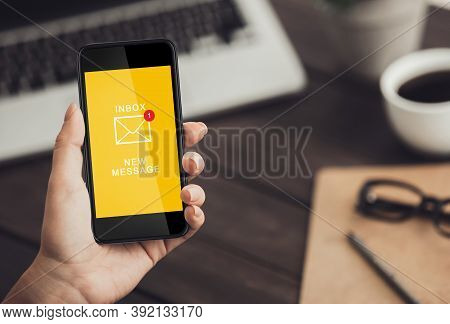 Online Communication. Businesswoman Using Mobile Phone With New E-mail Message Notification On Scree