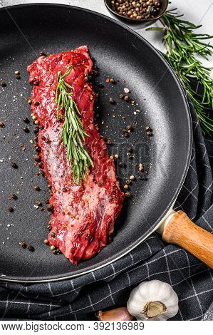 Raw Marbled Beef Steak, Fillet In A Pan With Ingredients For Cooking. Gray Background. Top View