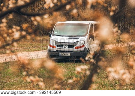 Chernigov, Ukraine - April 20, 2020: Minibus Renault Trafic In The Forest. Flowering Tree In The For