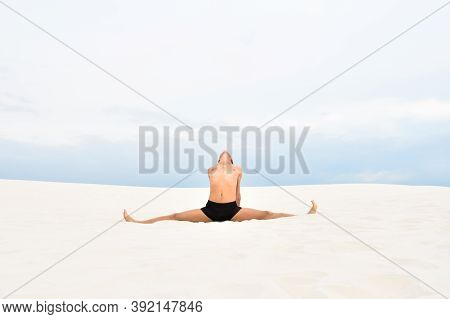 Young Man In Yoga Pose Samakonasana On The Beach