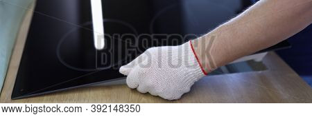 Close-up Of Professional Worker Setting Cookstove In Kitchen Room. New Modern Cooker. Man Wearing Pr