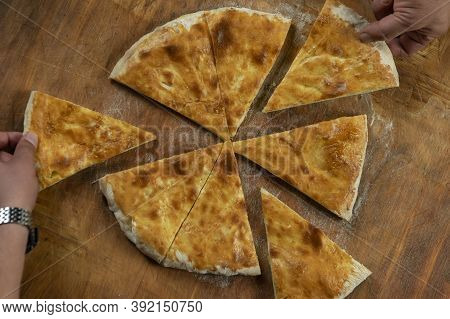 Baked homemade  cheese pie on wooden background. Bulgarian banitsa, Georgian khachapuri, Greek tirop