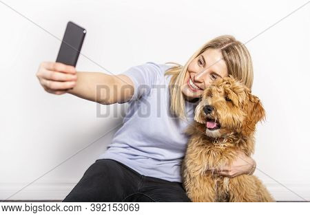 Woman With His Golden Labradoodle Dog Isolated On White Background