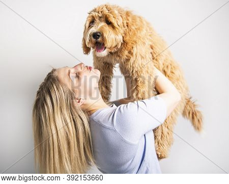 Woman With His Golden Labradoodle Dog Isolated On White Background