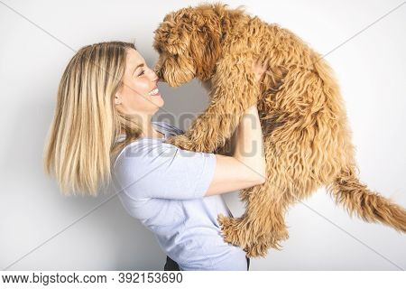 Woman With His Golden Labradoodle Dog Isolated On White Background