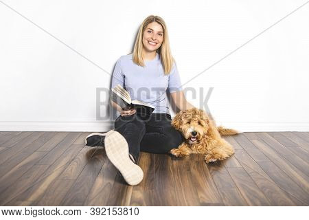 Woman With His Golden Labradoodle Dog Reading Book Isolated On White Background