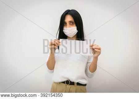 Young Caucasian Woman With Tired And Exhausted Eyes Holds In Hands Showing White Envelope With Blank