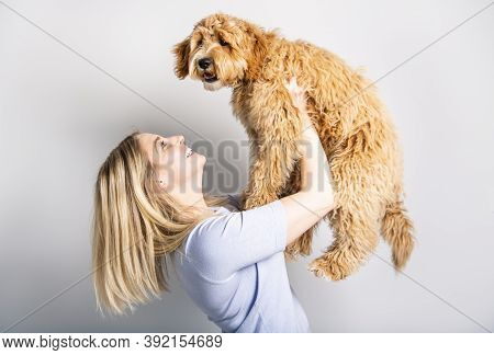 Woman With His Golden Labradoodle Dog Isolated On White Background