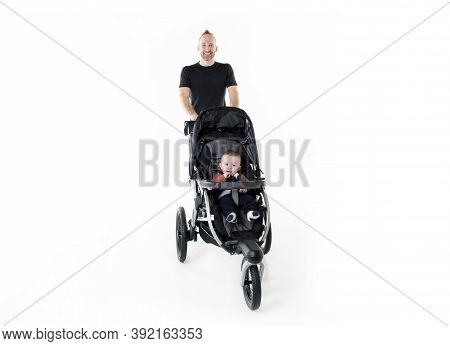 A Father Jogging With A Baby Stroller