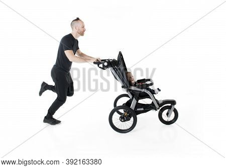A Father Jogging With A Baby Stroller