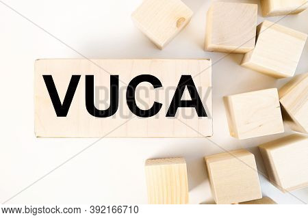 Vuca, Text On Wood Bar On A Light Background Near Wood