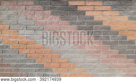 The Wall On The Street Is Made Of Ceramic Tiles Of Different Colors, Laid Out In Oblique Rows. The W