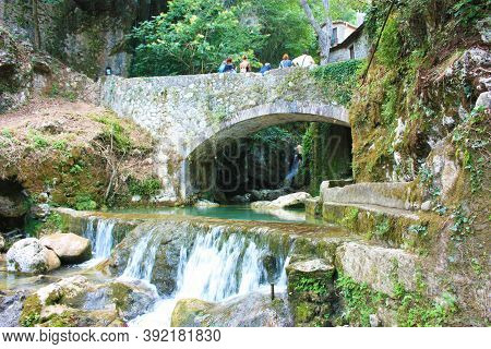 Rocky Bridge Of Candalla Over The River Waters In The Tuscan Mountains In Italy On Summer