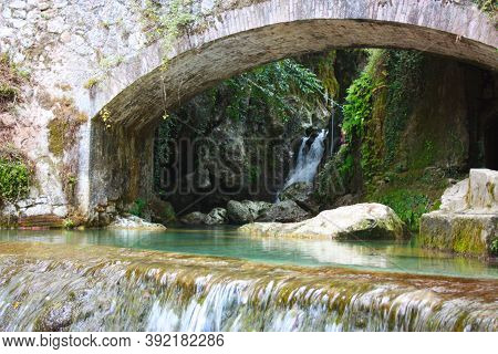 Rocky Bridge Of Candalla Over The River Waters In The Tuscan Mountains In Italy On Summer