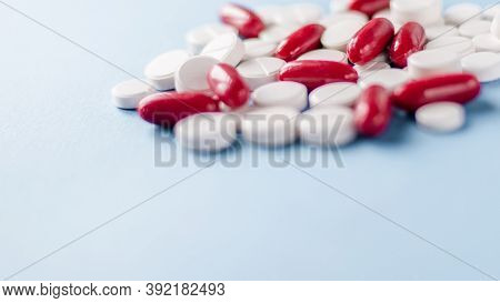 Red And White Pills On The Table. Closeup. Medical Capsules. Medicine. Pharmaceuticals. Bioactive Ad