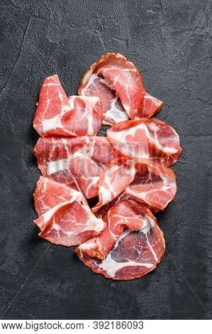 Italian Rolled Bacon Pancetta Piacentina. Pork Meat. Black Background. Top View