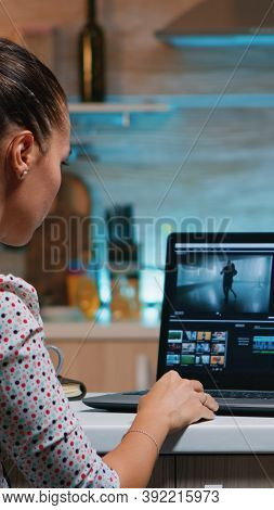 Video Editor Working From Home At Night At New Project Editing Audio Film Montage Sitting In Modern 
