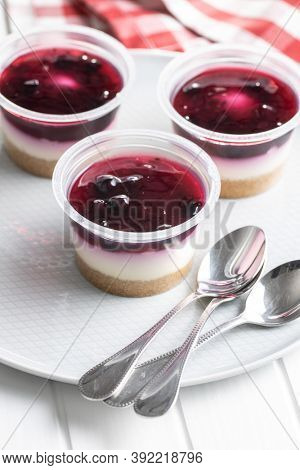 Sweet desssert. Cheesecake cup on plate.