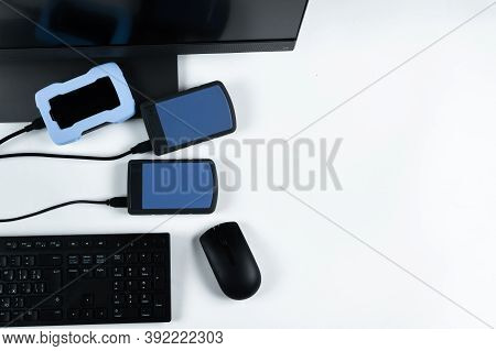 Multiple External Hard Drives Connected To A Monoblock On A White Background.computer With Hard Driv