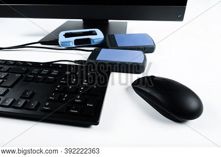 Multiple External Hard Drives Connected To A Monoblock On A White Background.computer With Hard Driv