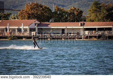 Man Being Pulled On A Wakeboard On A Lake