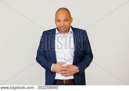 Portrait Of A Sick Young African American Businessman Guy, With A Hand On His Stomach Due To Indiges