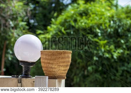 A Container Of Glutinous Rice Made From Bamboo And A Light Bulb With A Green Nature Behind The Blur