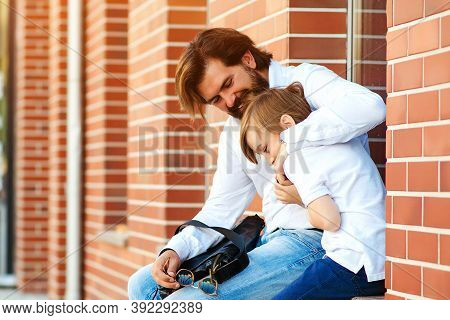 Happy Father And Son Walking At City Street Together. Dad Hugging His Kid Outsude. Family Spending T