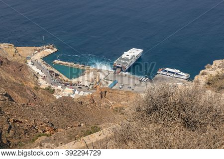 Ormou Athiniou, Santorini Island, Greece- 19 2020: View Of The New Harbor Of Thira. Passenger Ferry 