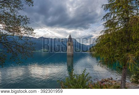 The Bell Tower Of The Sunken Church In Curon, Resia Lake, Bolzano Province, South Tyrol, Italy.