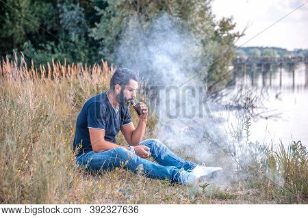 Confident Man Releases A Cloud Of Steam. Getting Rid Of Nicotine Addiction.