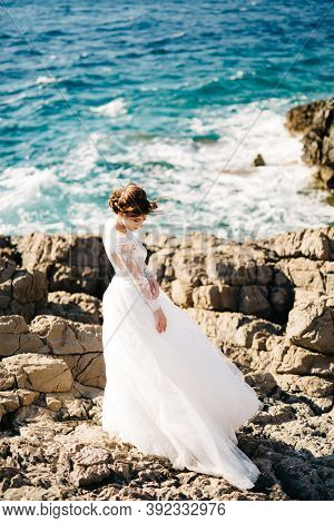 Beautiful Bride In Tender Wedding Dress On The Rocky Beach Of The Mamula Island