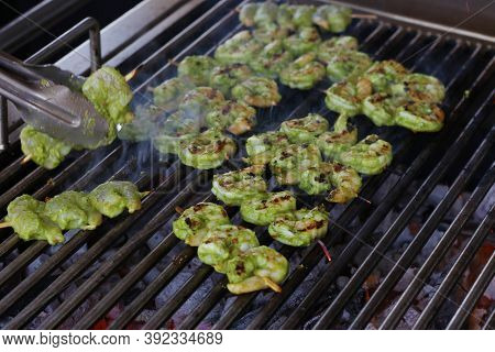 Spice Marinated Prawns Skewers On A Charcol Grill