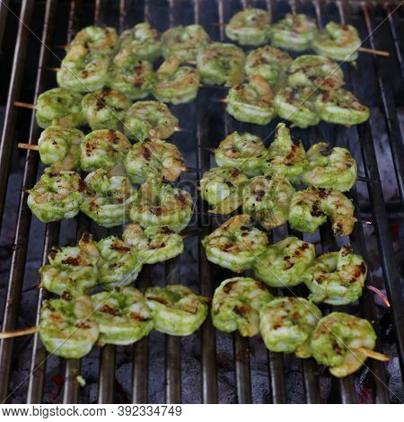 Spice Marinated Prawns Skewers On A Charcol Grill