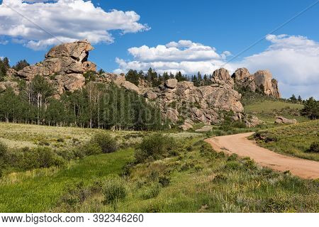 A County Road Passes By Dramatic Rock Formations In Castle Rock Park In Central Colorado.\ncastle Pa