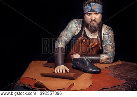 Professional Tanner Working With Leatherwork At The Workplace