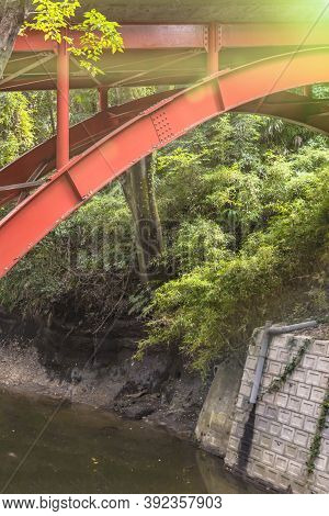 Red Metal Bridge Of Todoroki Park In The Setagaya District Of Tokyo.