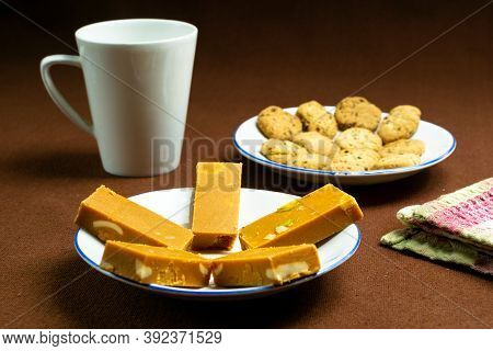 Focused On The Sweet Barfi And Rest Faded Off On A Brown Background