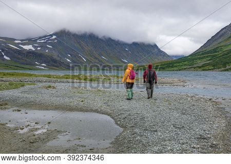 Two Tourists In The Mountains Of The Polar Urals On A Cloudy August Day. Yanao, Russia