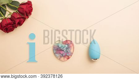 Rose Heart And Clitoral Vibrator On A Beige Background. Flat Lay