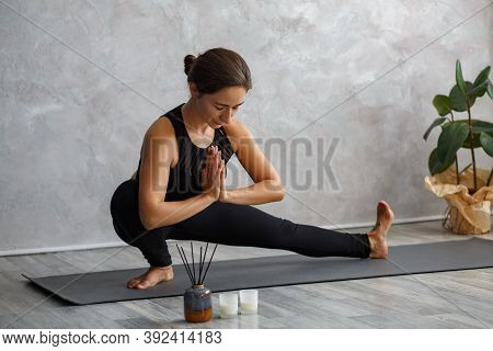 Portrait Of Sporty Young Woman Doing Exercises On Yoga Lesson At Home.beautiful Girl Practicing Side