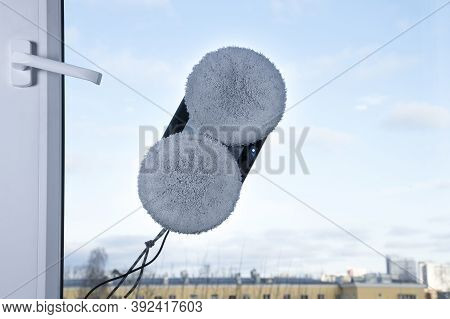 Downside Of Vacuum Cleaner Robot For Washing Glass Window On Clean Blue Sky Background. Robot Assist