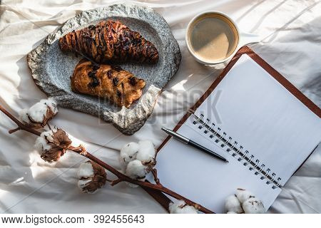 Coffee Mug With Croissant And Empty Notebook And Pencil For Business Plan And Design Ideas Onon Whit